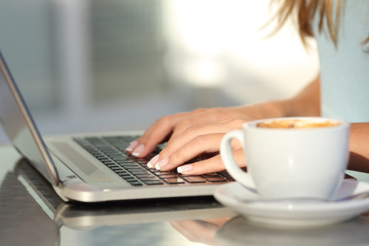 Lady using a laptop from the popular computer brands you can buy online