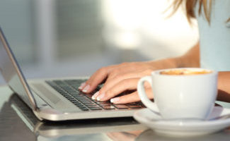 Lady using a laptop from the popular computer brands you can buy online